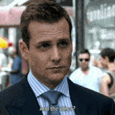 a man in a suit and tie asks and the other