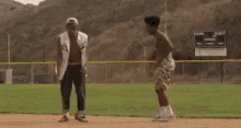 a man in a chicago cubs jersey stands next to another man on a baseball field