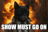 a black cat in a suit and tie smoking a cigarette with the words show must go on below him