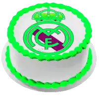 a white cake with green frosting and the real madrid logo