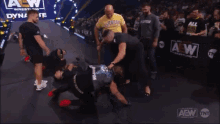 a group of men standing around a wrestler wearing a black bellator shirt