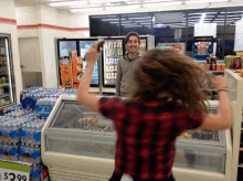 a man stands behind a woman in a store with a sign that says $ 29.99