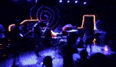 a person is playing drums in a dark room