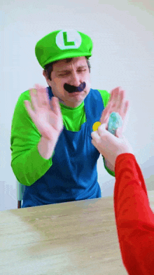 a man dressed as luigi is giving someone a coin