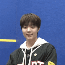 a young man wearing a black sweatshirt with the letter d on it