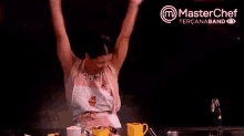 a woman is standing in front of a master chef logo