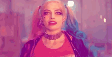 harley quinn from suicide squad is wearing a choker and pigtails and looking at the camera .
