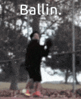 a blurry picture of a person holding a ball with the word ballin above them