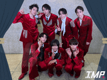a group of young men in red suits pose for a photo with tmp written in the corner