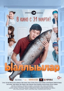 a man is holding a large fish in his hands in front of a group of children .