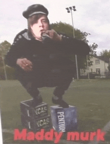 a man squatting on a stack of boxes that say pentium on them