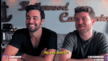 two men are sitting next to each other and one of them is saying no you didn 't