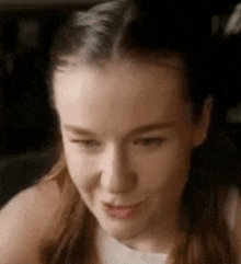 a close up of a woman making a funny face .