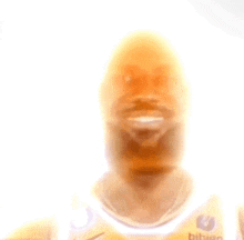a man with a beard is wearing a yellow nike jersey .