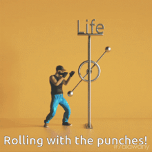 a man is standing next to a life punching machine