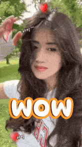 a woman in a white shirt with the word wow on the bottom