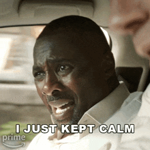a man sitting in a car with the words " i just kept calm " below him