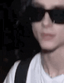 a close up of a person wearing sunglasses in the dark .
