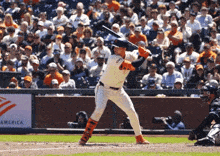 a san francisco giants baseball player getting ready to swing his bat
