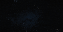 a large spider is crawling through a dark forest at night