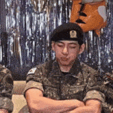 a man in a military uniform has the letter i on his chest