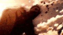 a close up of a person 's face against a cloudy sky in a cartoon .
