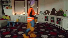 a girl in an orange vest is standing next to a teddy bear