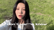 a woman is taking a selfie in a field with the words `` i don t wanna know '' behind her
