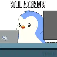 a penguin is sitting at a desk with a laptop and the words still working