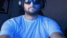 a man wearing sunglasses and headphones is taking a selfie