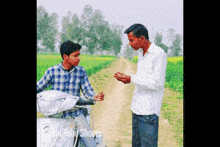 two men standing on a dirt road with youtube shorts on the bottom right