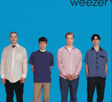 four men standing in front of a blue background with weezer written on the bottom