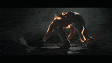 a blurred image of a person in a dark room with a light coming out of their back