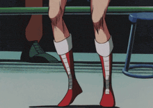 a woman 's legs are shown in red and white boots