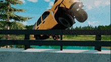 a yellow car is upside down on a bridge in a video game