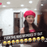 a woman wearing a pink beret is behind a sign which says even she was weirded tf out
