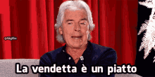 a man with gray hair is sitting on a couch with the words la vendetta e un piatto below him