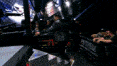 a man in a black leather jacket is standing in a boxing ring with tna written on the pole