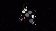 a man playing drums in a dark room with a smokey background