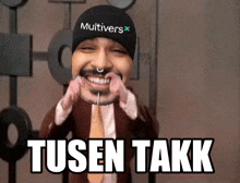 a man wearing a beanie that says multivers on it is smiling
