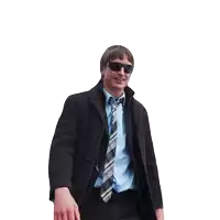 a man wearing sunglasses and a plaid tie is walking