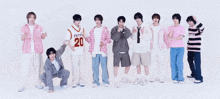 a group of young men are standing next to each other and one of them is wearing a jersey with the number 20 on it