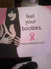 a poster that says " feel your boobies " on it