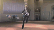 a man in a suit and sunglasses is dancing in a room