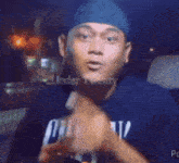 a man wearing a blue hat and a shirt that says crunchy is smiling .