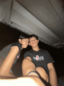 a man wearing a vintage t-shirt poses with a woman