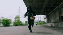 a person in a superhero costume is running with a cake