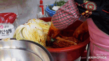 a bag of white sugar sits next to a bowl of vegetables