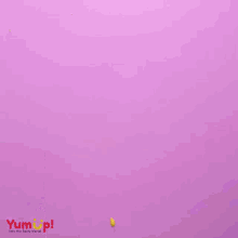 a cake pan with a chocolate frosting in it and the words yumup below it