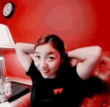 a woman in a black shirt with a red heart on it
